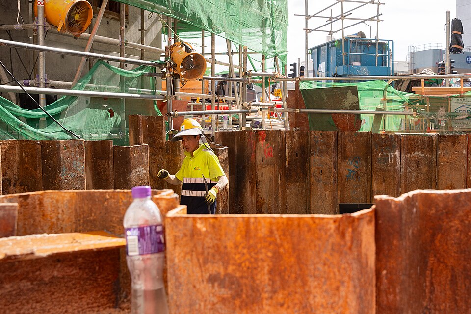 Construction worker wearing a safety helmet and vest on site